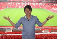 Shinji Kagawa poses infront of the Stretford End after his transfer to Manchester United from Borussia Dortmund.